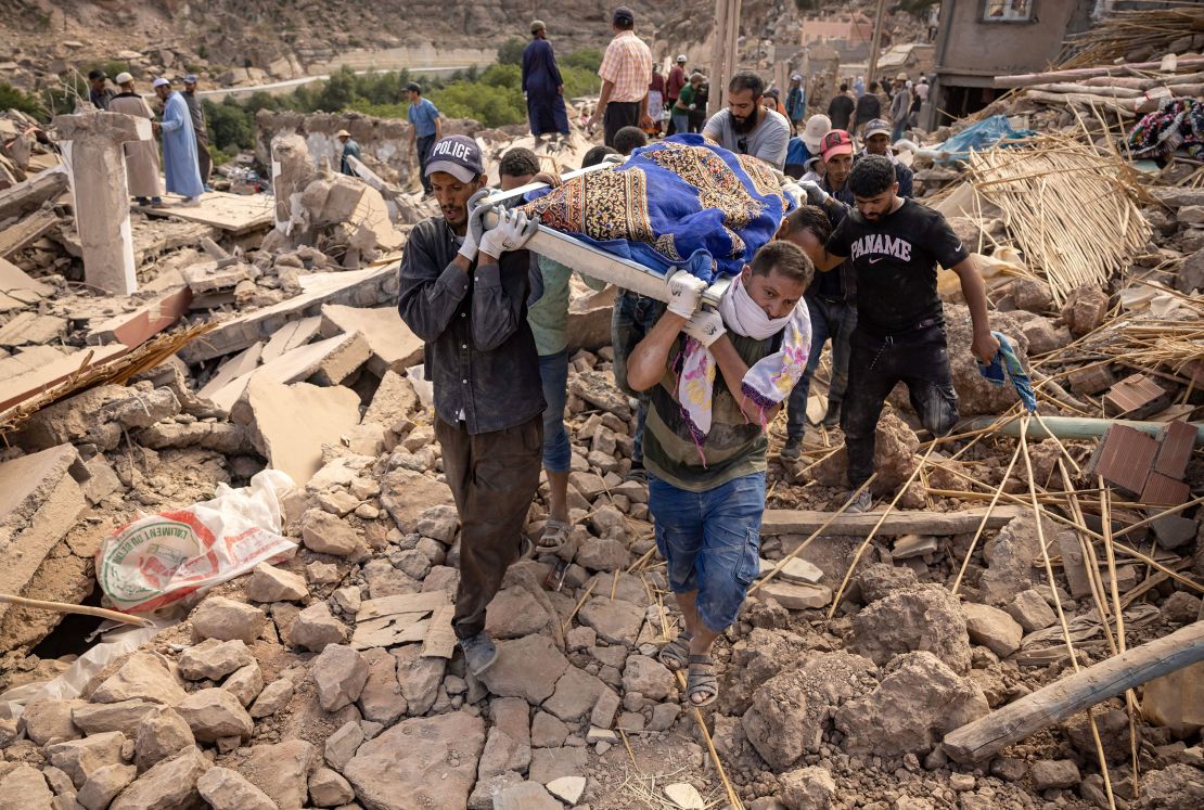 People carrying the remains of a victim, in the village of Imi N'Tala.