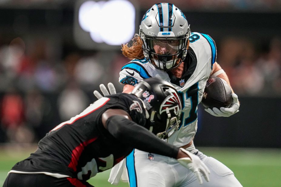 Carolina Panthers tight end Hayden Hurst tries to stiff arm Atlanta Falcons safety Richie Grant in the first half at Mercedes-Benz Stadium. It was all for naught as the Falcons won the game 24-10.