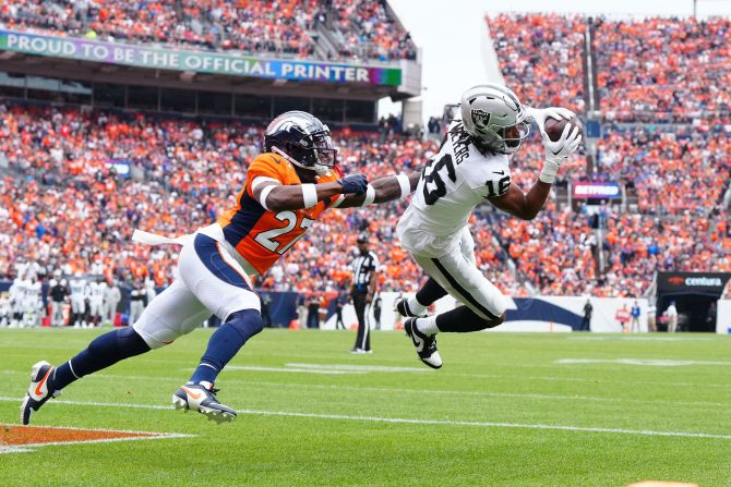 Las Vegas Raiders wide receiver Jakobi Meyers pulls in a touchdown past Denver Broncos cornerback Damarri Mathis in the first quarter at Empower Field at Mile High on September 10. The score would be important as the Raiders edged the home side, 17-16.