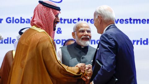 India's Prime Minister Narendra Modi (center), US President Joe Biden (right) and Saudi Arabia's Crown Prince Mohammed bin Salman (left) hold hands before the start of a session at the G20 summit in New Delhi, India on Saturday. 