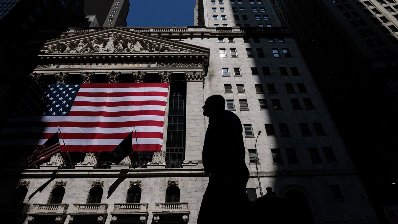 People walk past the exterior of the New York Stock Exchange in New York, New York, USA, 30 May 2023. 