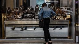 A pedestrian views diamond jewelry in the window of a store in the Diamond District neighborhood of New York, U.S., on Thursday, May 5, 2022. 