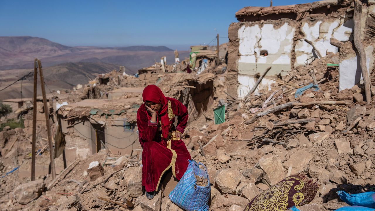 DOUZROU, MOROCCO - SEPTEMBER 11: A woman sits amongst the rubble of her village that was almost completely destroyed by Friday's earthquake, on September 11, 2023 in Douzrou, Morocco. Over 2600 people are now reported dead following the large earthquake that struck below villages in the High Atlas mountains around 70km south of Marrakesh. (Photo by Carl Court/Getty Images)