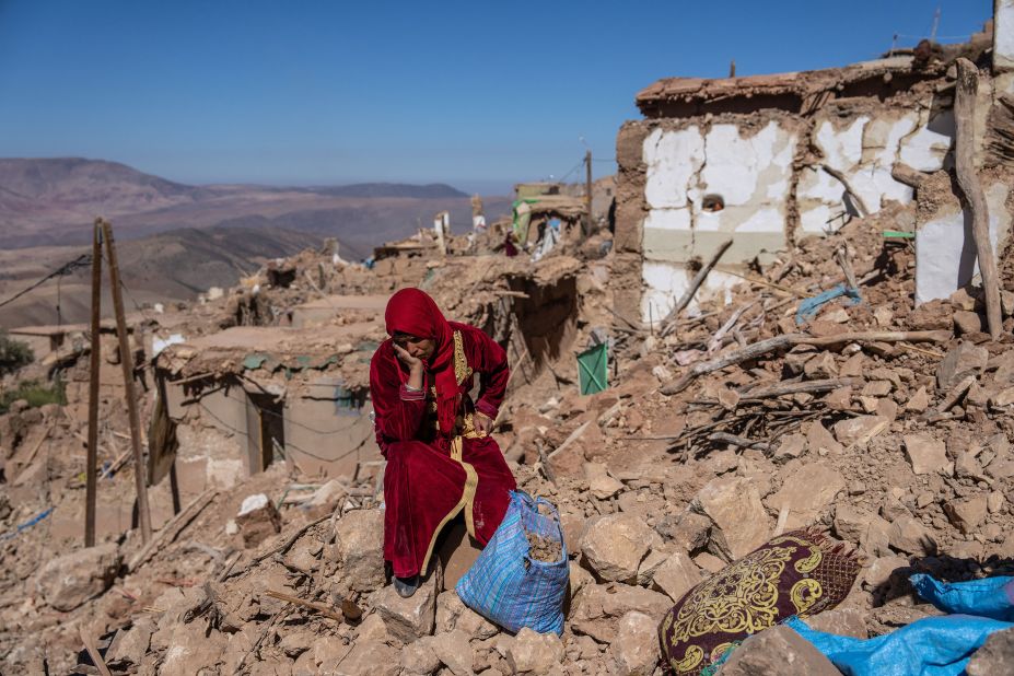 A woman sits amid the rubble of her village in Douzrou, Morocco, on Monday, September 11.