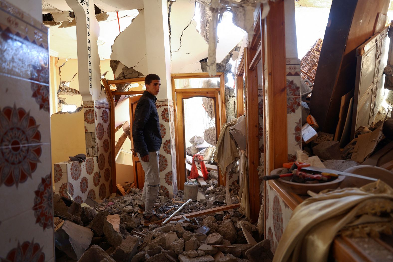 Mouath Aytnasr walks in his damaged house on the outskirts of Talat N'Yaaqoub on September 11. He lost his 7-year-old brother, Suleiman, in the earthquake.