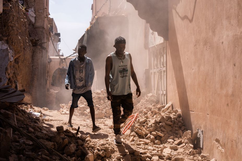 People walk along an alleyway filled with rubble in the Old City district of Marrakech on September 11.