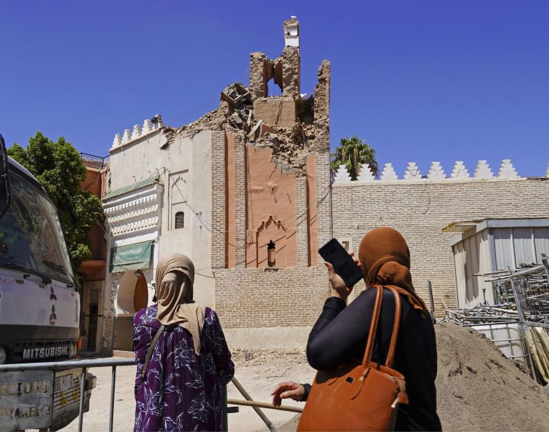 Women look up at the damaged Kharbouch Mosque in Marrakech on Sunday, September 10.