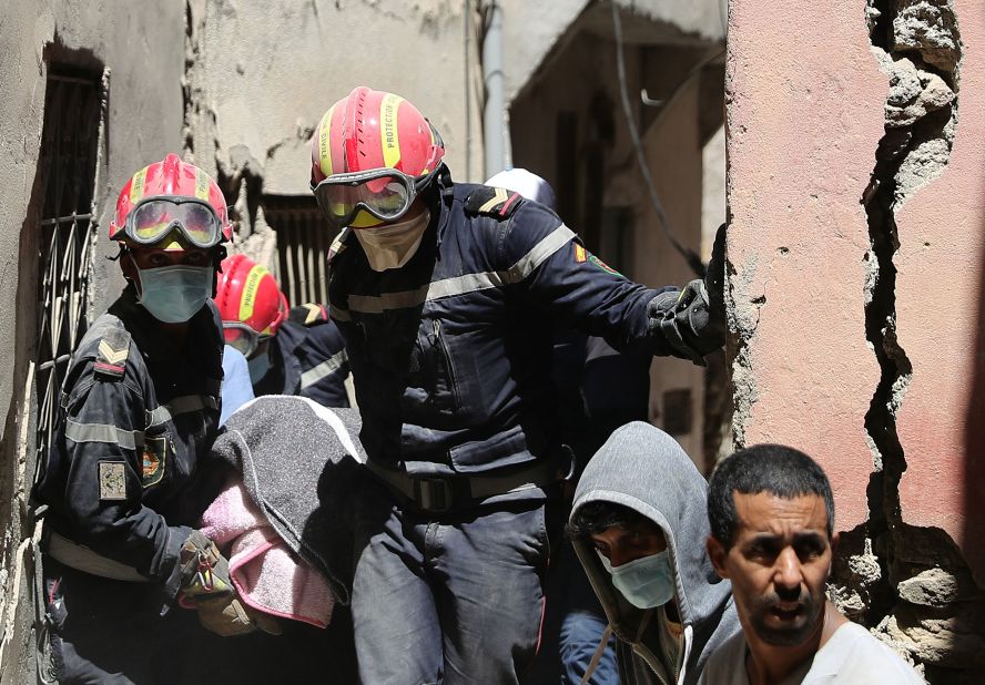 Rescuers carry a victim's body in the village of Amizmiz on September 10.