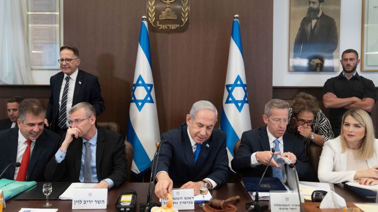 Israeli Prime Minister Benjamin Netanyahu eats an apple slice to mark the upcoming Jewish New Year holiday at a weekly meeting of his Cabinet in Jerusalem, Sunday, Sept. 10, 2023.