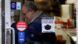 A Face Mask Required sign is displayed on a store on March 6, 2023 in New York City. 
