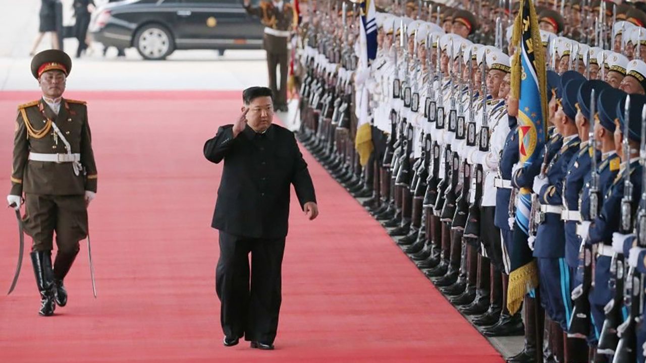 Kim Jong Un walks down a red carpet to a crowd of onlookers and officials before boarding his private train.