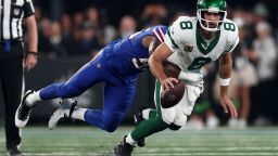 Quarterback Aaron Rodgers #8 of the New York Jets sacked by defensive end Leonard Floyd #56 of the Buffalo Bills during the first quarter of the NFL game at MetLife Stadium on September 11, 2023 in East Rutherford, New Jersey. 