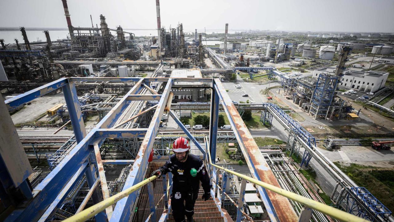 A Total Energies employee walks in the Donges oil refinery in Donges, western France, on September 8, 2023. The Donges refinery is the second largest refinery in France. (Photo by LOIC VENANCE / AFP) (Photo by LOIC VENANCE/AFP via Getty Images)