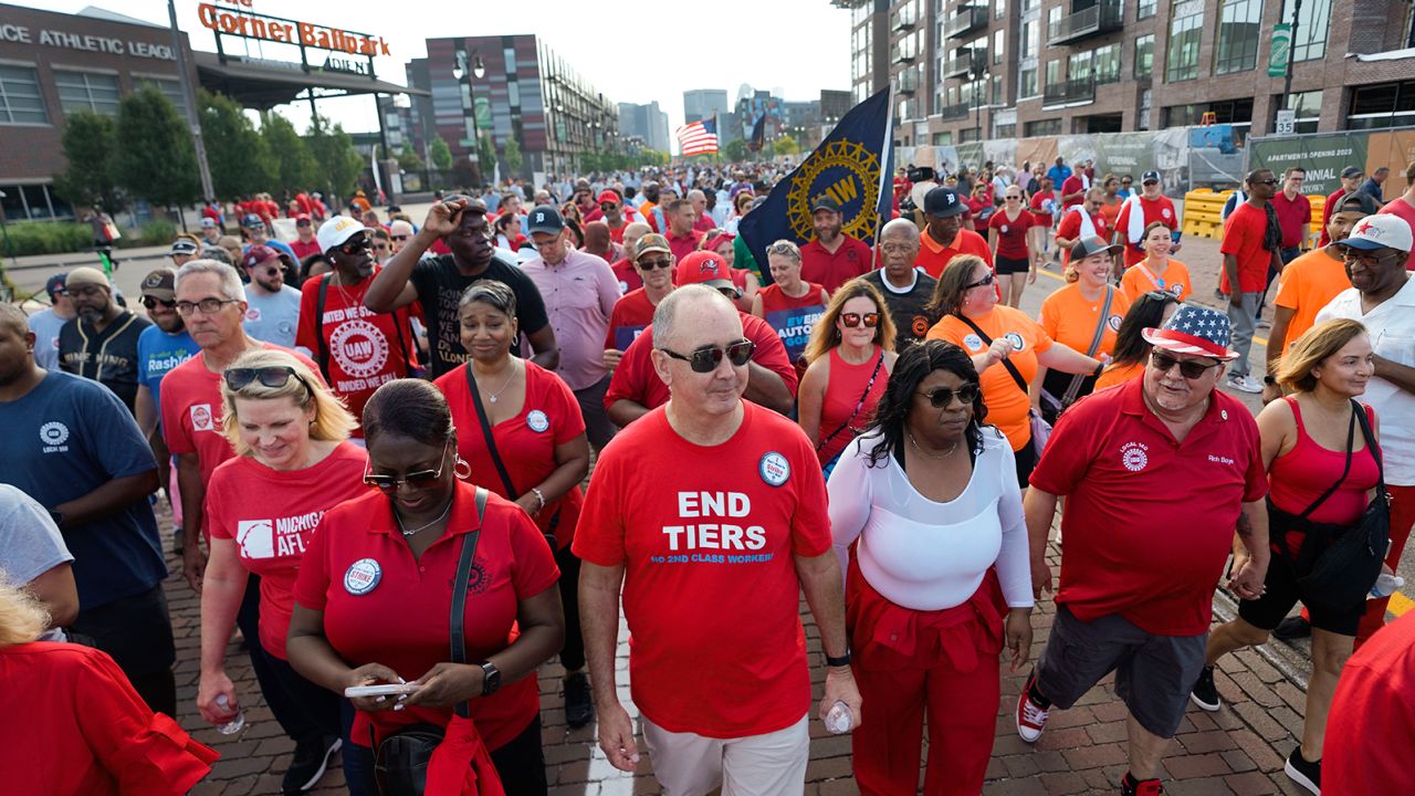 United Auto Workers President Shawn Fain, middle, walks in the Labor Day parade in Detroit, Monday.
