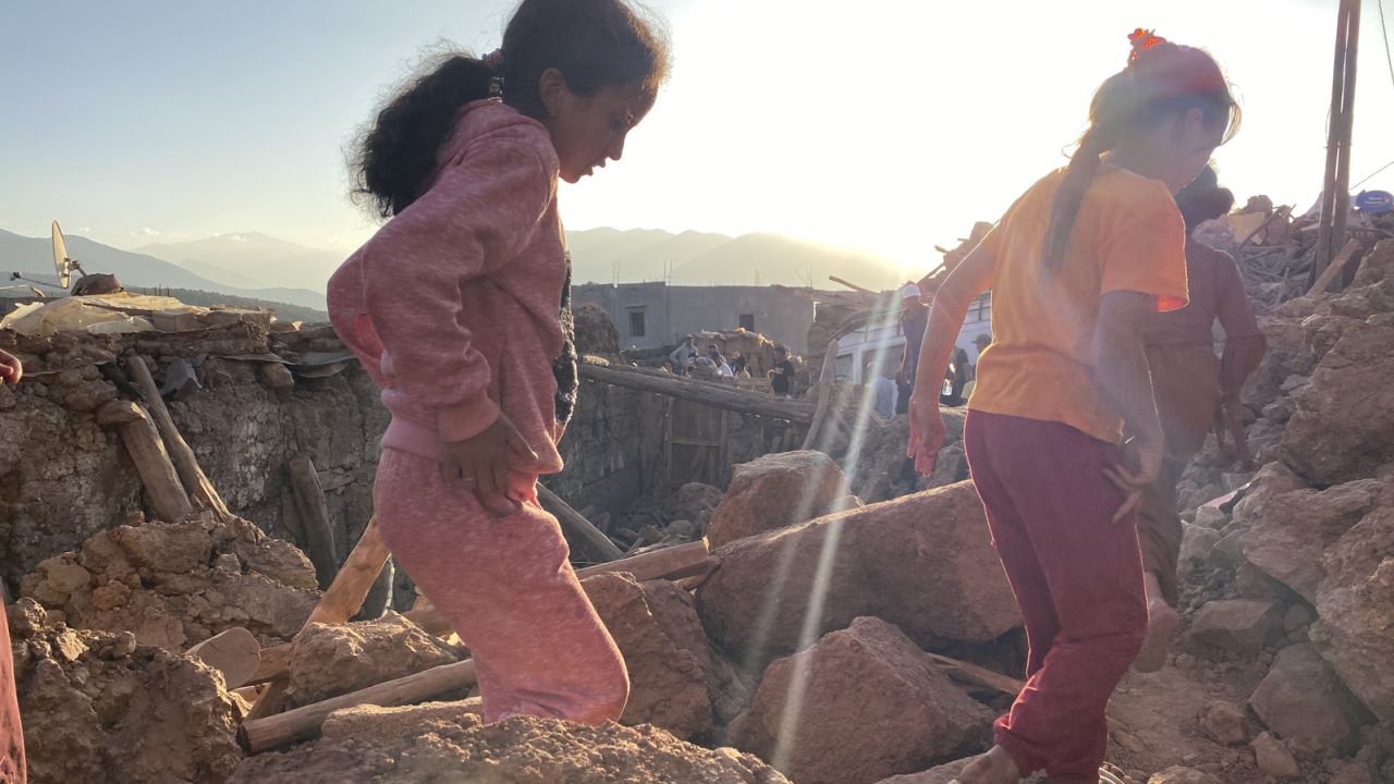 Children make their way through the destroyed village of Tinzert.