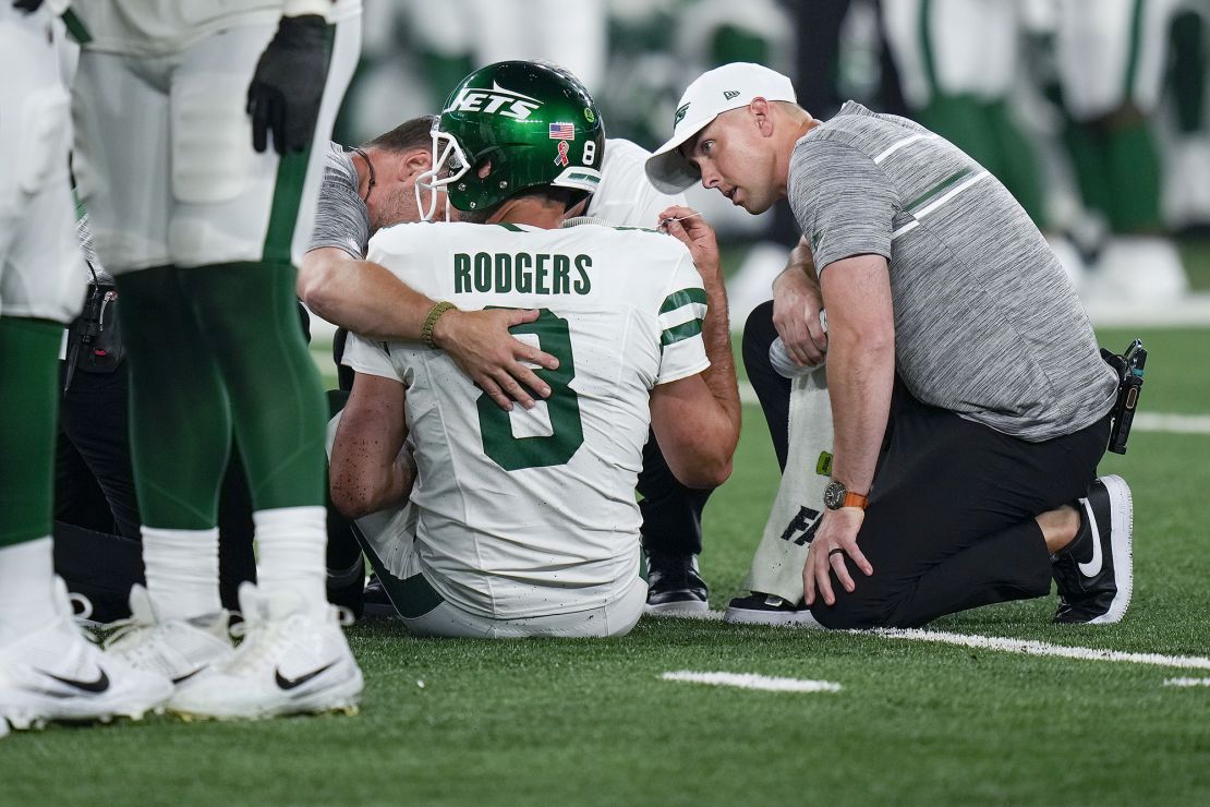 New York Jets quarterback Aaron Rodgers (8) is tended to on the field during the first quarter of an NFL football game against the Buffalo Bills, Monday, Sept. 11, 2023, in East Rutherford, N.J. (AP Photo/Seth Wenig)