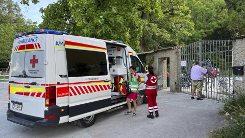 An ambulance with rescue helpers of the Red Cross stands at the entrance of the Hellbrunn Zoo in Salzburg, Austria, Tuesday, Sept. 12, 2023. Police say a rhino at a zoo in Austria has attacked and killed a zookeeper and seriously injured another. The fatal attack happened early Tuesday morning at the Hellbrunn zoo in the western Austrian city of Salzburg. Police said in a statement that during routine work in the rhino enclosure, a 33-year-old animal keeper was attacked by the animal 'for reasons that are still unknown'. (AP Photo)