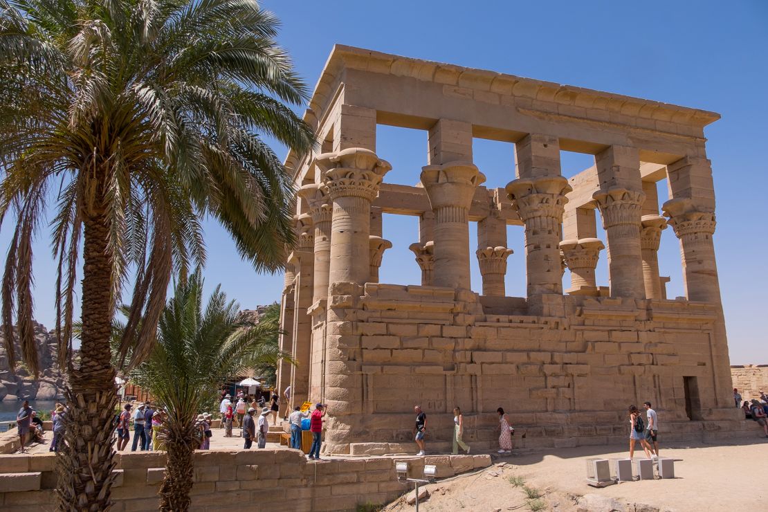 Aswan, Egypt - April 28, 2023: Palm trees and Trajan's pier on Agilkia Island