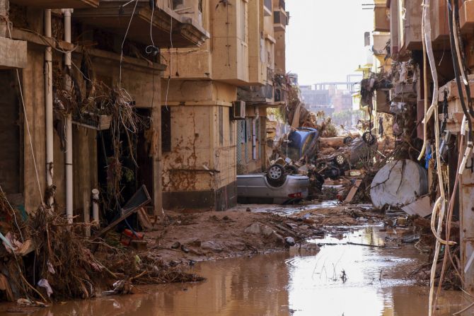 Overturned cars are piled in a street in Derna on September 11.