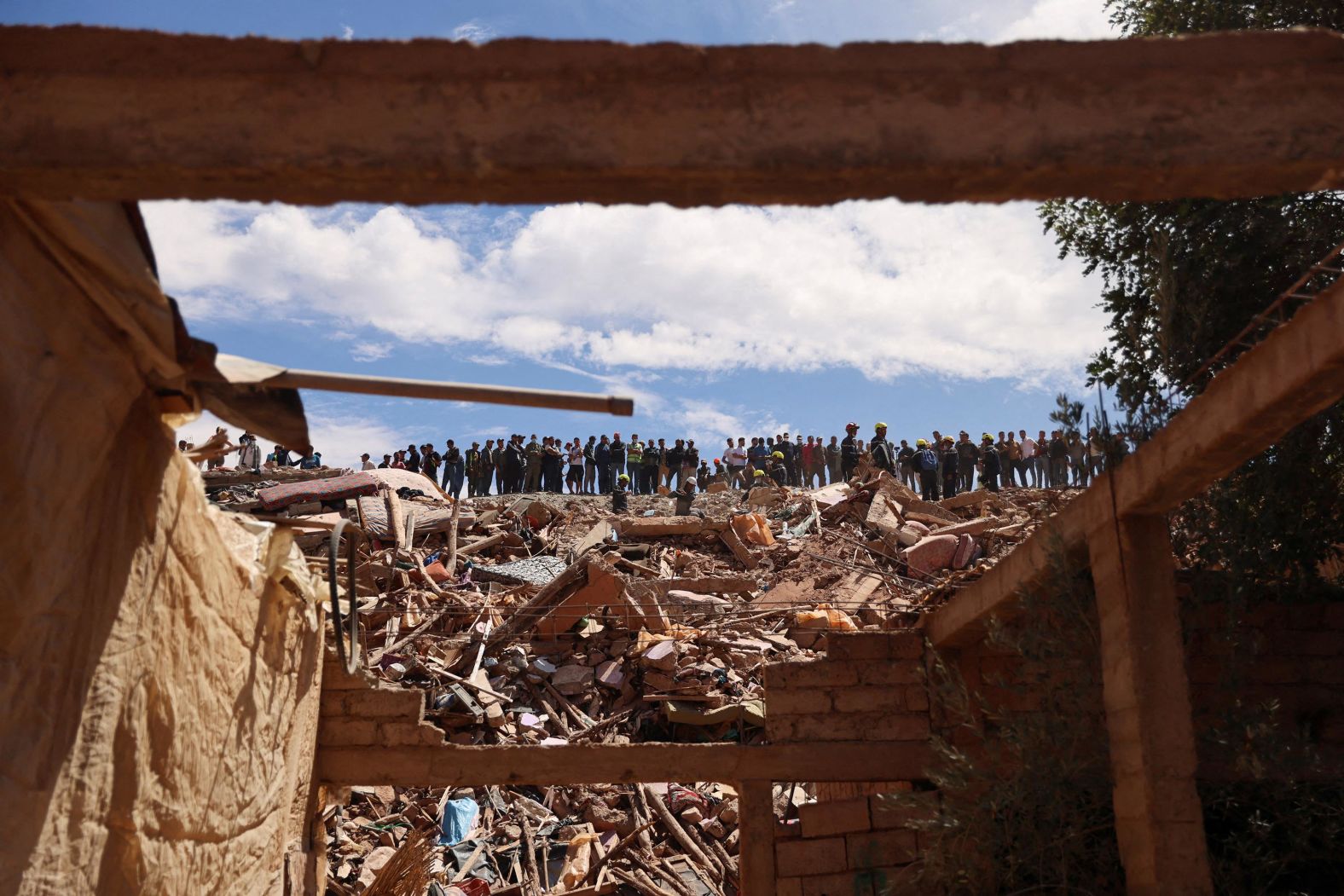 A crowd watches firefighters work in Talat N'Yaaqoub on September 12.