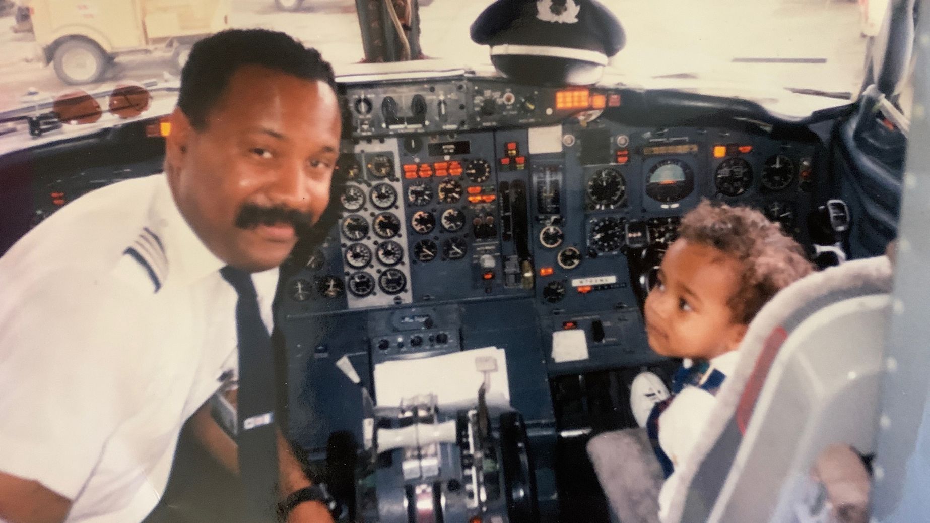 Here's Captain Ruben Flowers and his son Ruben Flowers photographed in an airplane cockpit in 1994.