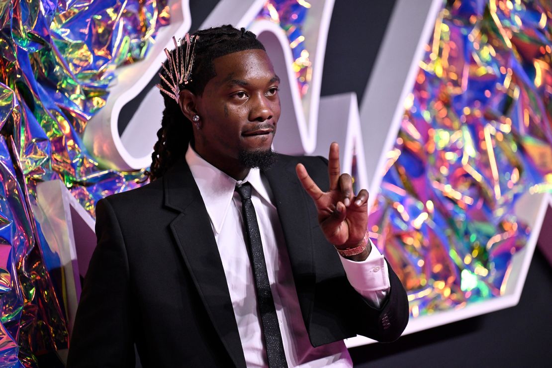 Offset adorned his hair with silver clips to match the dress worn by his wife Cardi B. The rapper also paired his dark suit with a black and silver buckled belt, sparkly skinny tie and silver jewelry.