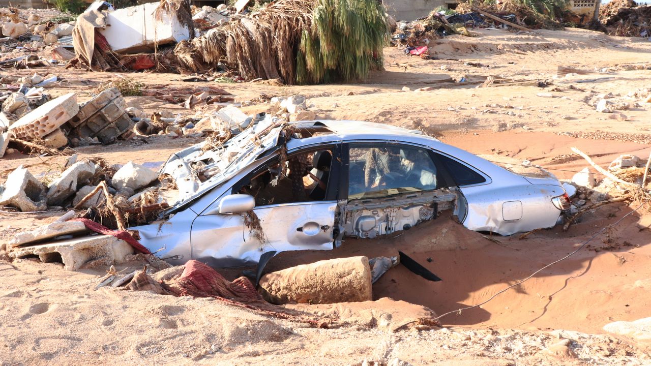 A damaged vehicle is stuck in debris after flooding caused by Storm Daniel in Derna on September 12.