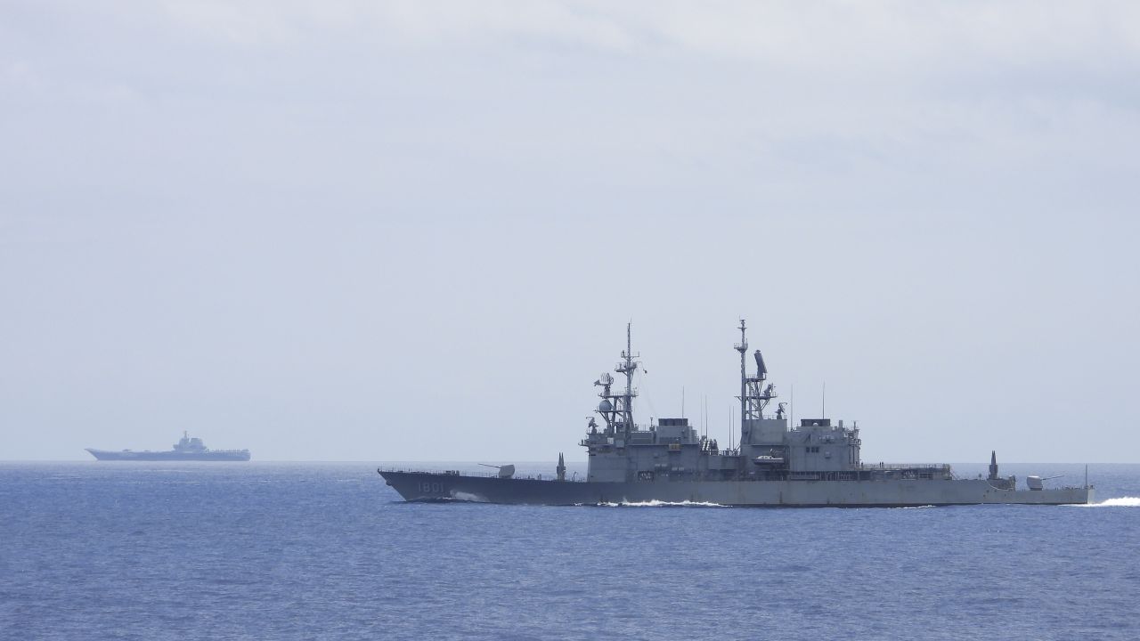 This photo released by Taiwan's Ministry of National Defense shows a Taiwanese navy ship monitoring the Chinese aircraft carrier, the Shandong, in waters near Taiwan.
