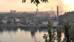 Smoke rises from the shipyard that was reportedly hit by Ukrainian missile attack in Sevastopol, Crimea, in this still image from video taken September 13, 2023. REUTERS TV via REUTERS
