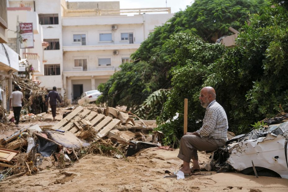 A man sits amid flood debris in Derna on September 12.