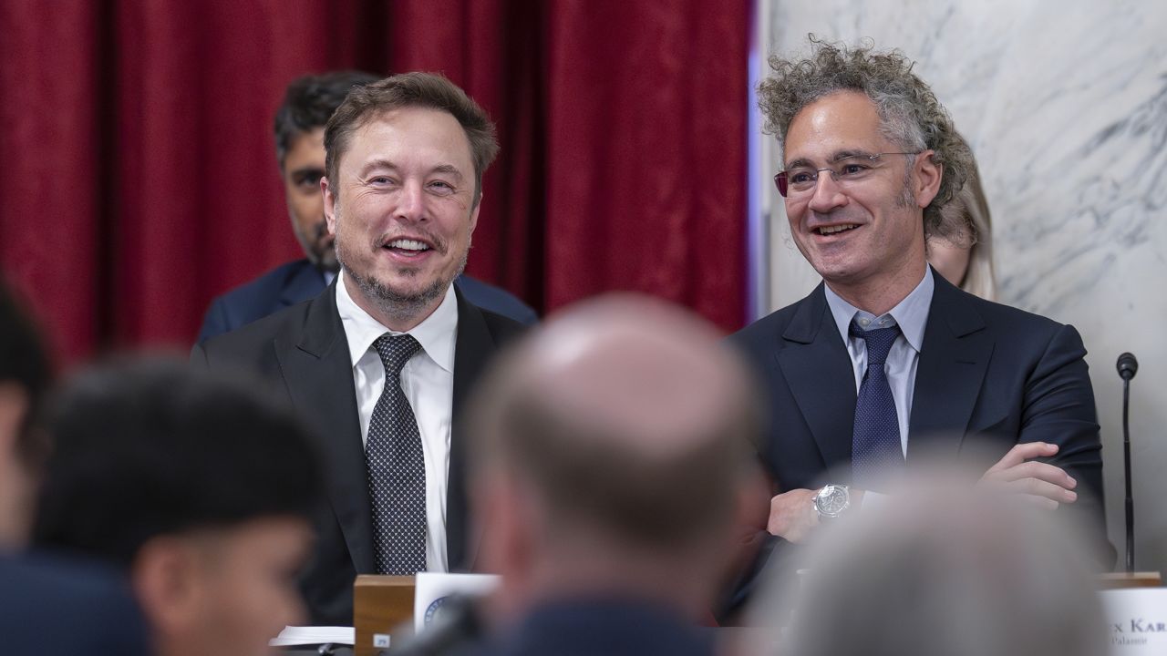 Elon Musk, CEO of X, the company formerly known as Twitter, left, and Alex Karp, CEO of the software firm Palantir Technologies, take their seats as Senate Majority Leader Chuck Schumer, D, N.Y., convenes a closed-door gathering of leading tech CEOs to discuss the priorities and risks surrounding artificial intelligence and how it should be regulated, at the Capitol in Washington, Wednesday, Sept. 13, 2023. 