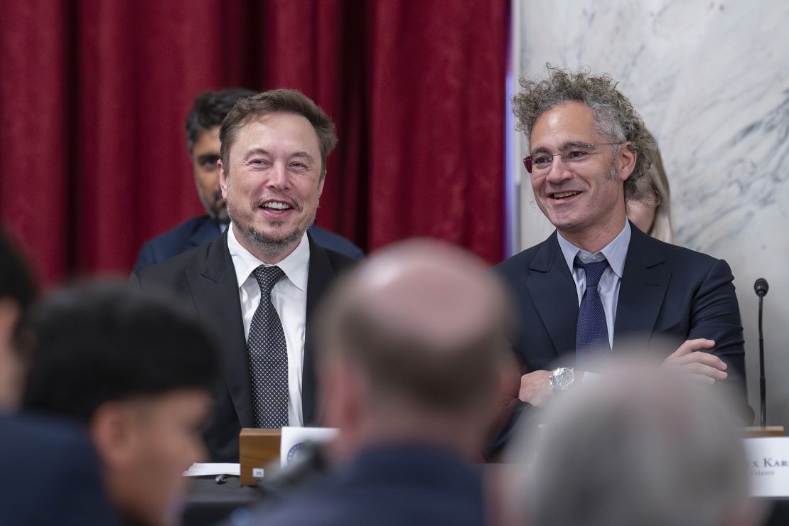 Elon Musk, CEO of X, the company formerly known as Twitter, left, and Alex Karp, CEO of the software firm Palantir Technologies, take their seats as Senate Majority Leader Chuck Schumer, D, N.Y., convenes a closed-door gathering of leading tech CEOs to discuss the priorities and risks surrounding artificial intelligence and how it should be regulated, at the Capitol in Washington, Wednesday, Sept. 13, 2023. 