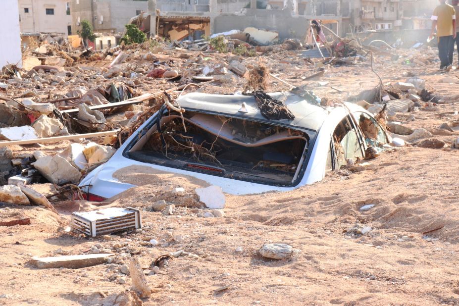 A damaged vehicle is partially buried in Derna on September 12.