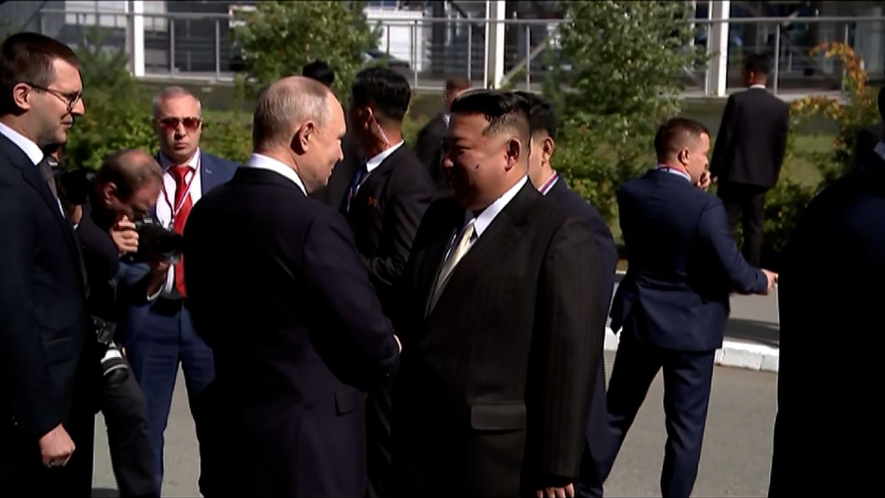 screengrab kim putin shake hands