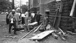 A civil defense worker and firemen walk through debris from an expolsion which struck the 16th street Baptist Church, killing and injuring several people, in Birmingham, Ala. on Sept. 15, 1963. The open doorway at right is where at least four persons are believed to have died. (AP Photo/Bill Hudson)