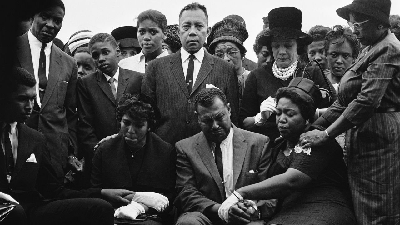 The family of Carole Robertson, a 14-year-old African American girl killed in a church bombing, attend graveside services for her, Sept. 17, 1963, Birmingham, Ala. Seated left to right: Carol Robertsons sister Dianne and parents, Mr. Alvin Robertson Sr. and Mrs. Alpha Robertson. The others are unidentified. (AP Photo/Horace Cort)