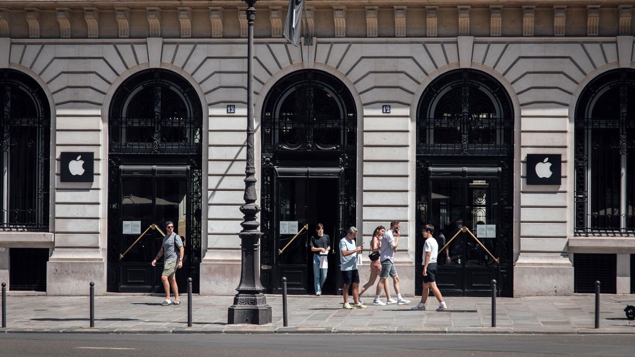 Customers exit an Apple Inc. store in the Opera district in Paris, France, on Sunday, July 24, 2022. 