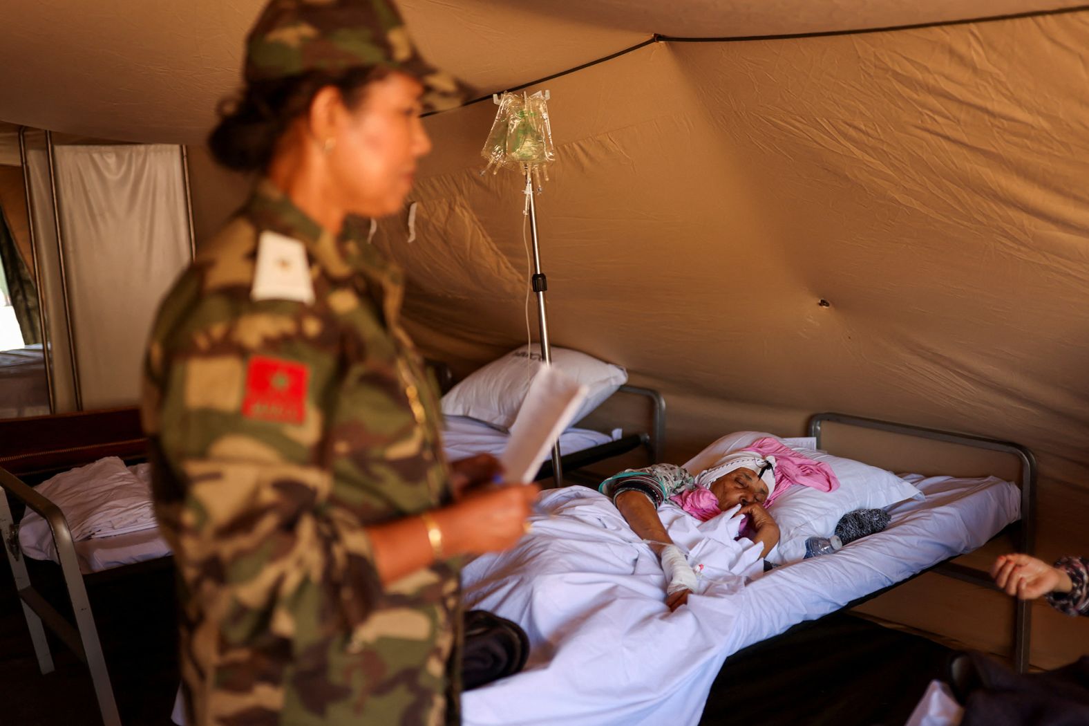 An earthquake survivor lies in bed at a field hospital in Asni, Morocco, on September 13.