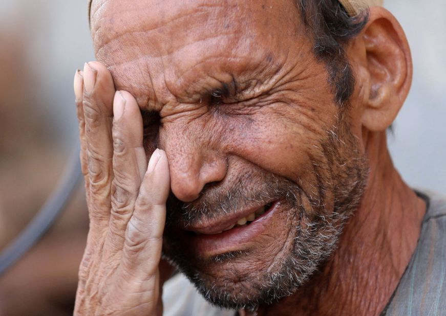 Hassan El Salheen weeps in the Egyptian village of Al Sharief on September 13 after burying the repatriated body of his son, Aly, who died along with his three cousins in Libya.
