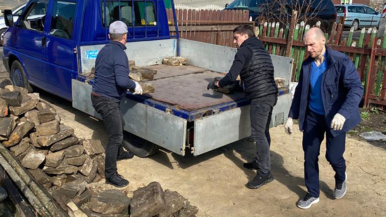 Artur Livshyts (center) helps to load some of the headstones collected from a house in Brest earlier this year.