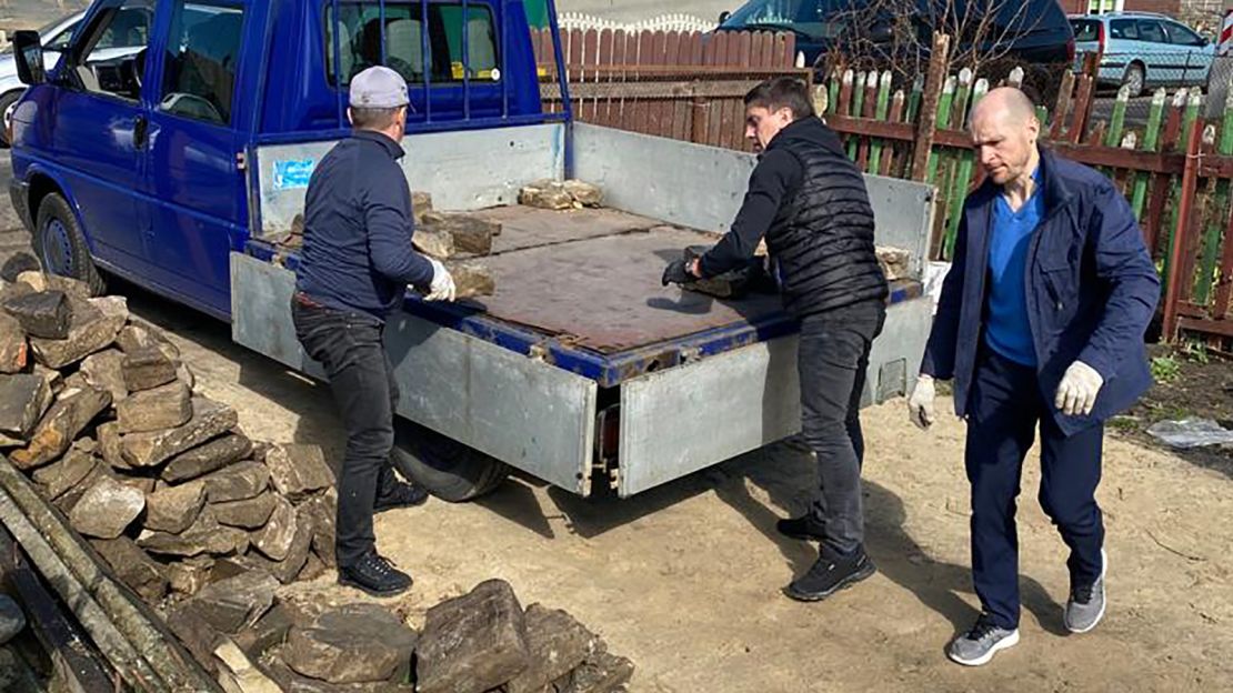 Artur Livshyts (center) helps to load some of the headstones collected from a house in Brest earlier this year.