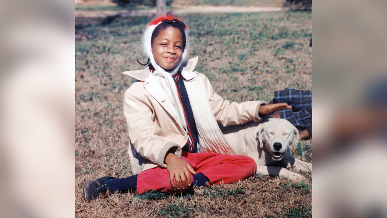 Denise McNair, one of the victims of the 16th Street Baptist Church bombing poses in the front yard with her dog Whitey in 1962 in Birmingham, Alabama.  (Photo by Chris McNair/Getty Images)
