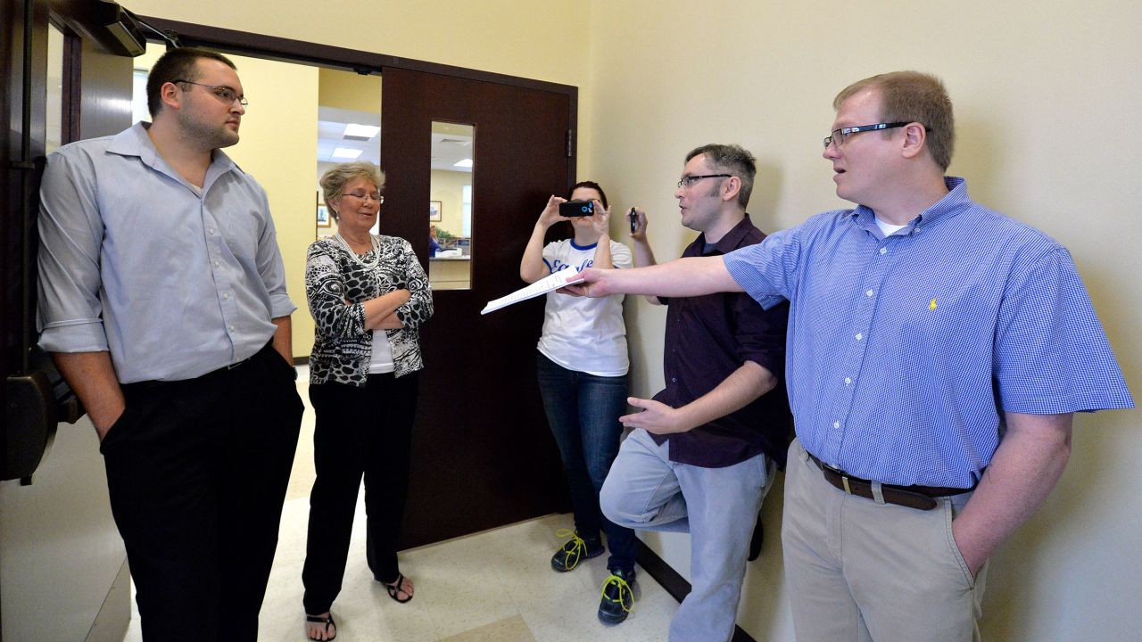 In 2015, David Ermold, right, attempts to hand Rowan County clerks a copy of the ruling from U.S. District Court Judge David Bunning instructing the county to start issuing marriage licenses.
