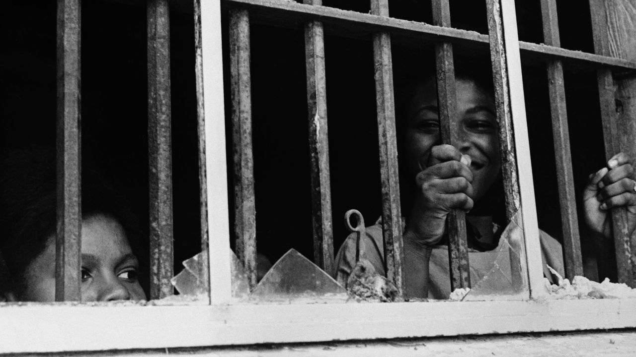 Shirley Reese holds onto the bars of the stockade window in Leesburg, Georgia, in 1963.
