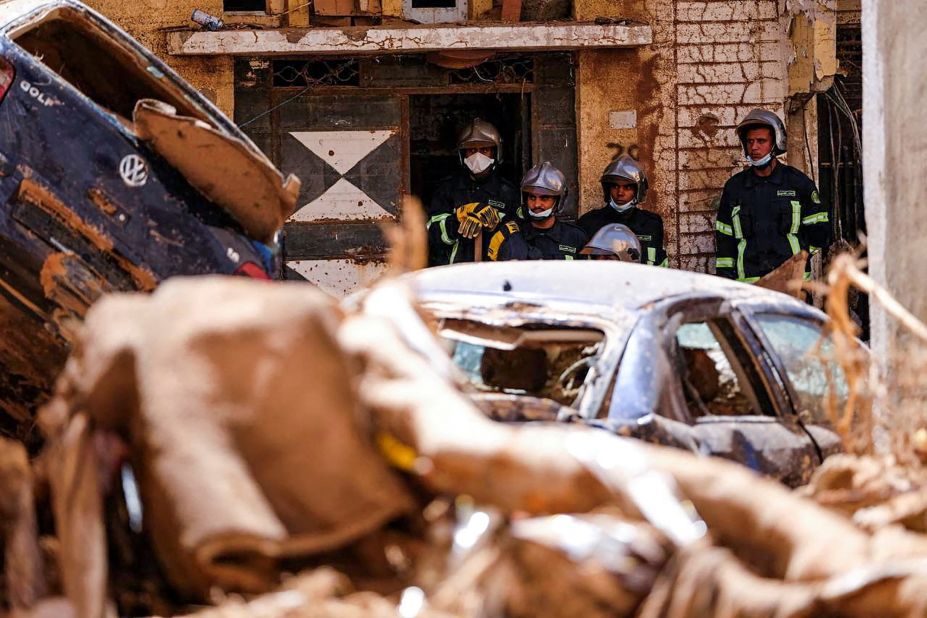 A search-and-rescue team from the Egyptian army looks at damaged cars in Derna on September 13.
