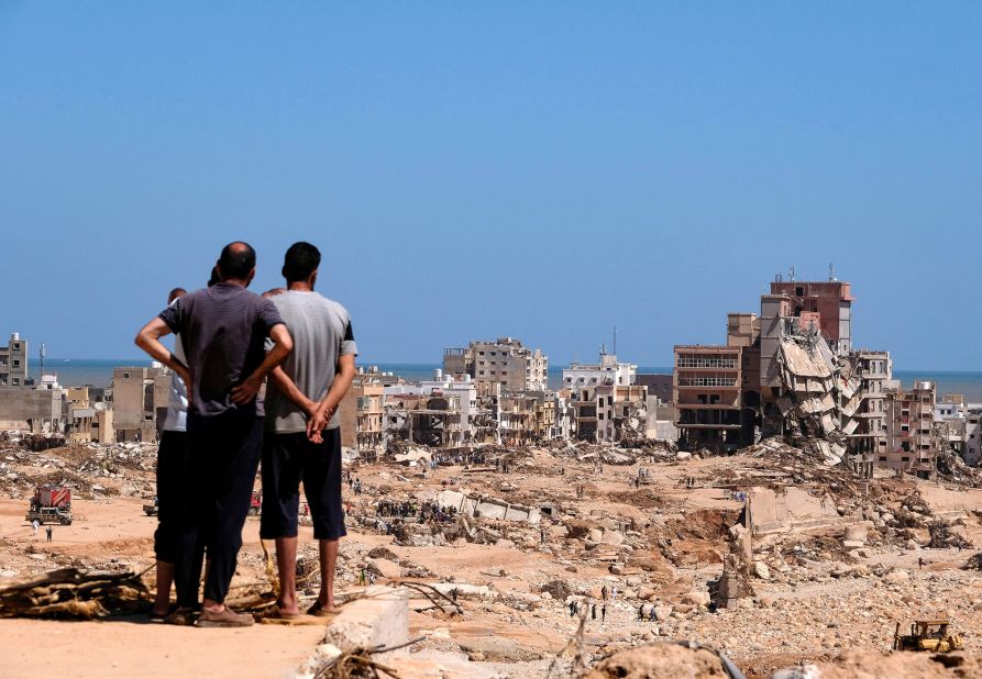 People look at damaged areas of Derna on September 14.