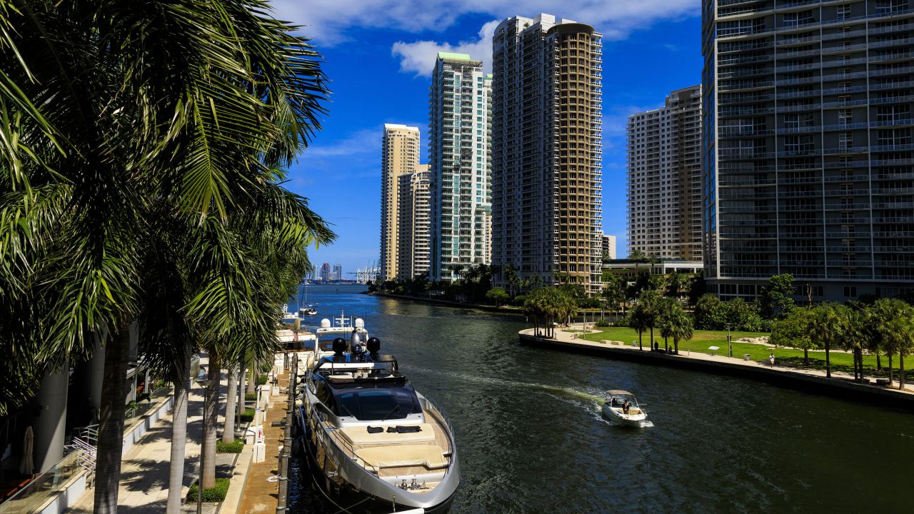 A boat travels along the Miami River in downtown Miami, Florida, on in August 2022. 