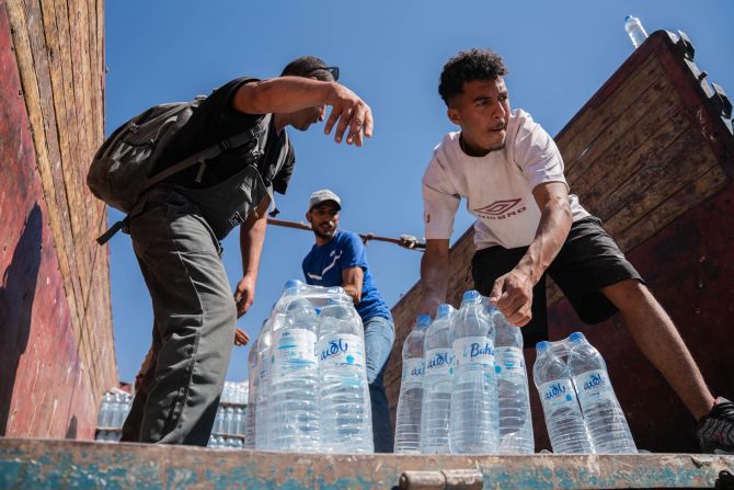 The Moroccan Civil Defense Institution provides water for earthquake victims as search-and-rescue operations continue in Talat N'Yaaqoub on Wednesday, September 13.