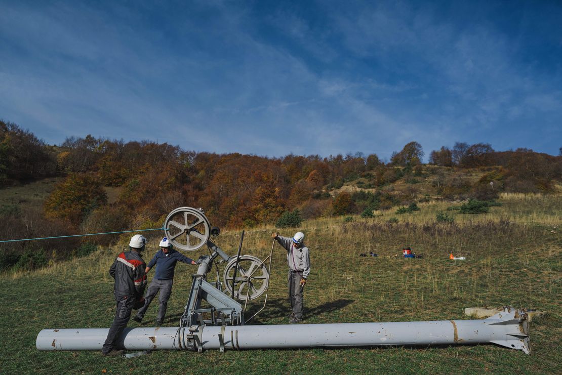 Workers dismantle the site of a ski lift in Saint Firmin in the Parc National des Ecrins between Grenoble and Gap, eastern France, on October 29, 2022. - At the signal, the volunteers pull on the rope and the first pylon falls under the cheers: in a few hours, the Saint-Firmin ski lift, abandoned to rust for fifteen years, will have completely disappeared from the landscape. The project, the 70th of its kind for the association, including twenty ski lifts, is part of its "Obsolete Installations" campaign, launched in 2001, which aims to clean up mountain sites in consultation with local authorities. (Photo by OLIVIER CHASSIGNOLE / AFP) (Photo by OLIVIER CHASSIGNOLE/AFP via Getty Images)