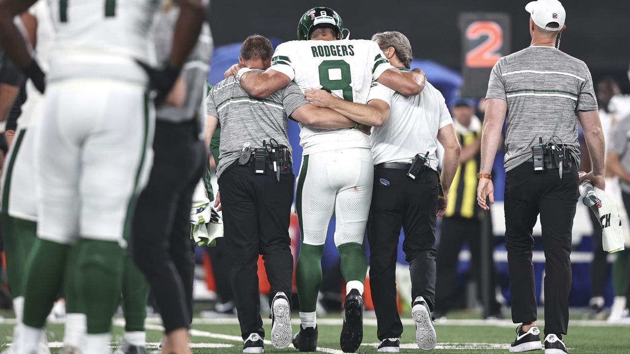 EAST RUTHERFORD, NEW JERSEY - SEPTEMBER 11: Aaron Rodgers #8 of the New York Jets is helped off the field for an apparent injury during a game against the Buffalo Bills at MetLife Stadium on September 11, 2023 in East Rutherford, New Jersey. (Photo by Michael Owens/Getty Images)